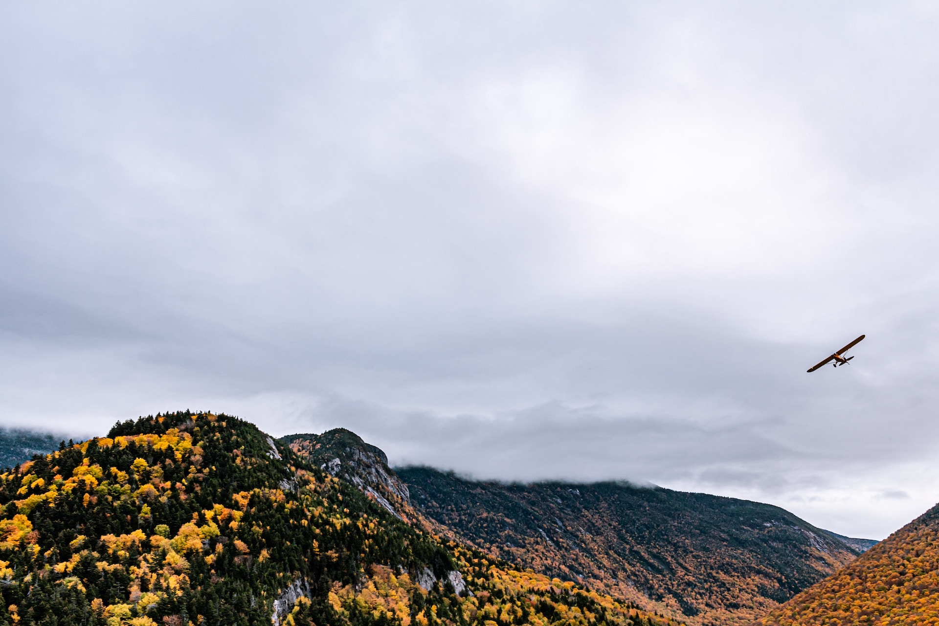 Franconia Notch in fall with plane above